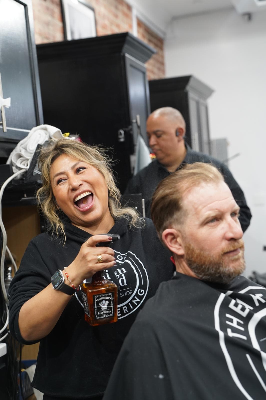 Master barber performing precision haircut at High End Barbershop